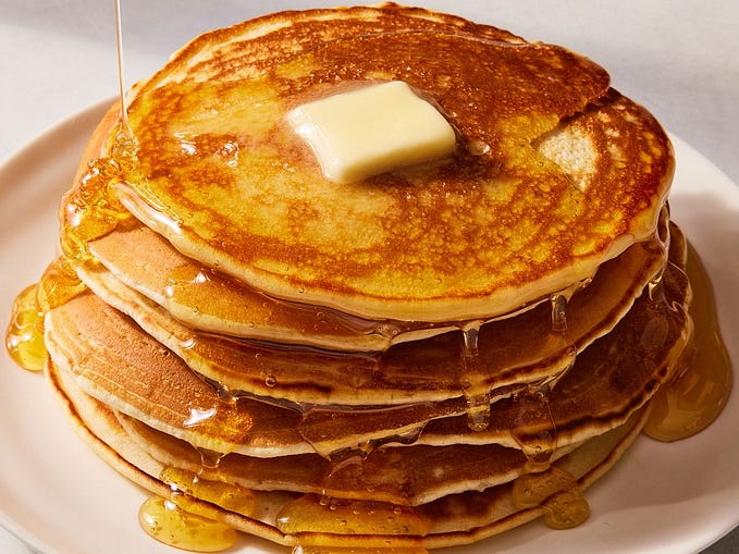 pancakes with honey stacked on top of each other